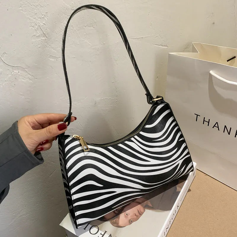 Small square PU underarm shoulder bag for women in assorted colours and animal print patterns.