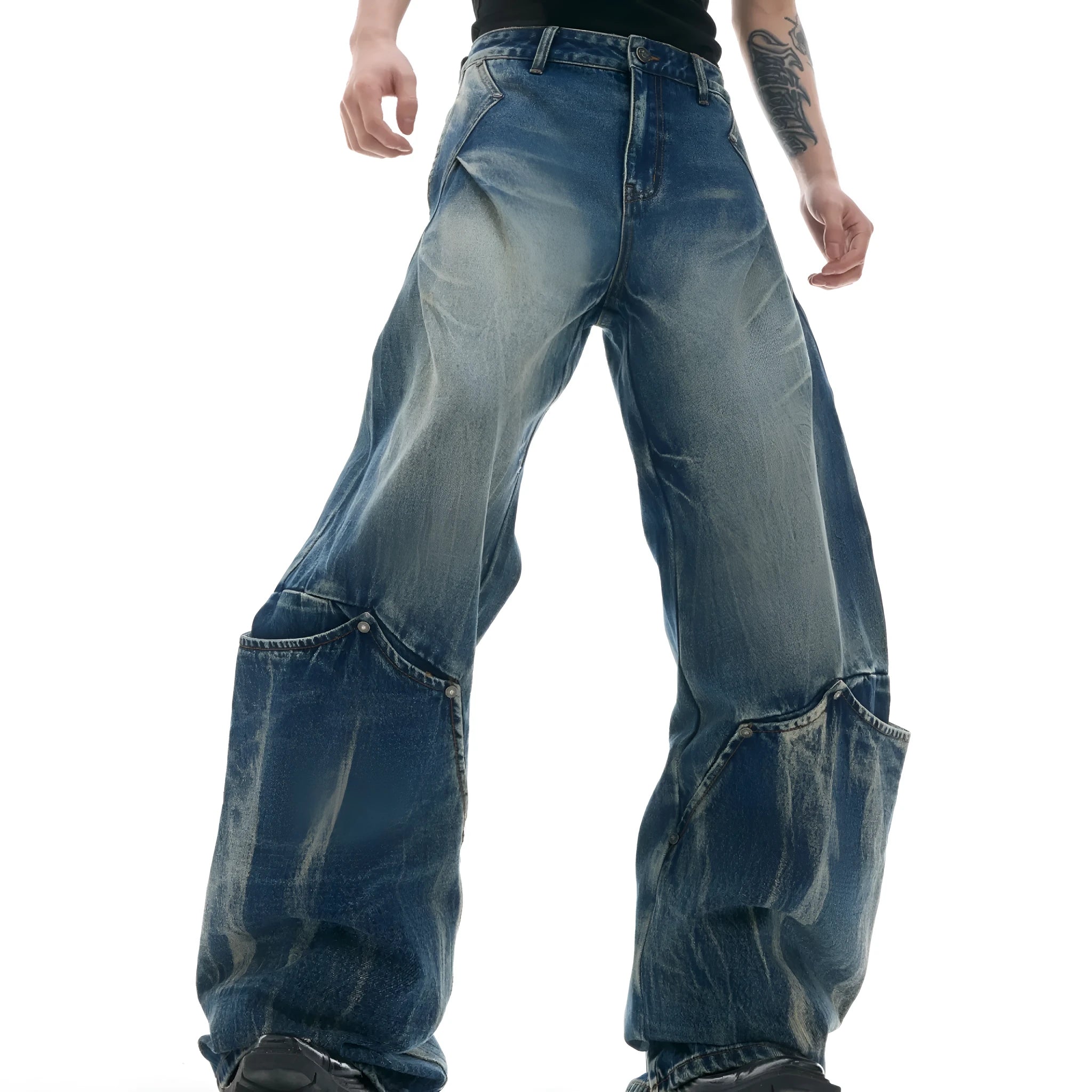 Men's verdant blue retro jeans with washed burst pattern showing curved knife fit and loose silhouette