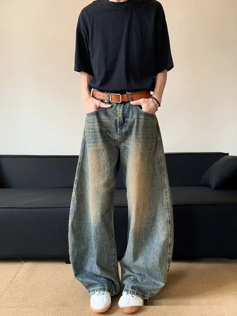 Men's retro blue distressed denim jeans with slim wide-leg cut and micro stretch fabric