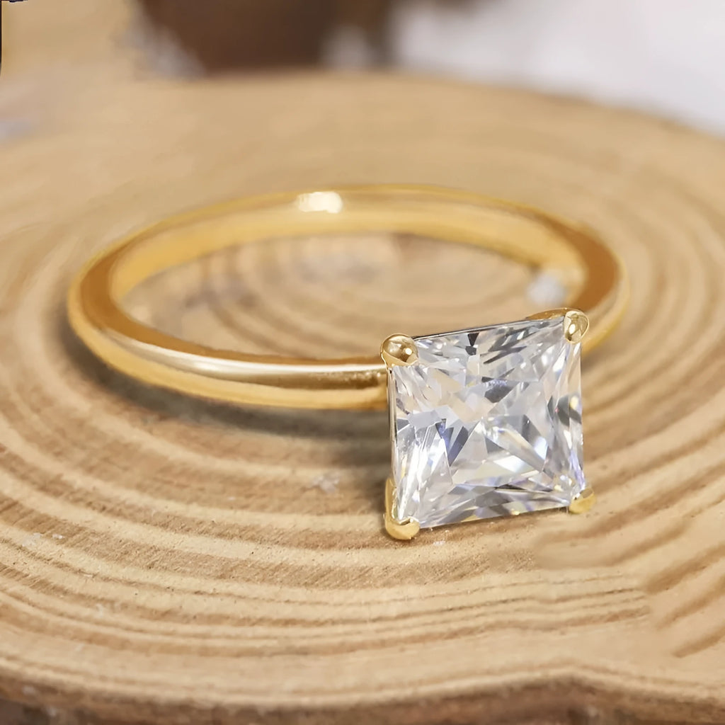 Simple geometric sterling silver ring with round stone on a woman's hand, shown in silver, gold, and rose gold colours.