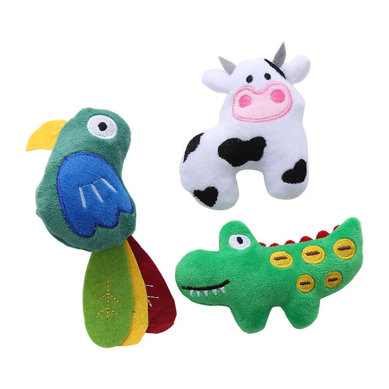 Plush cat toy in shape of a cow, a crocodile, and a parrot on a plain background.