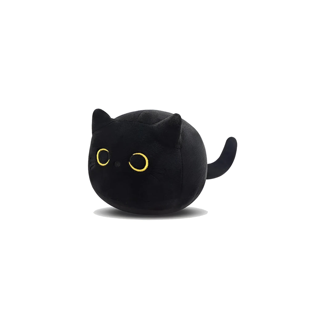 Fluffy black cat plush toy used as a soft pillow cushion on a sofa.
