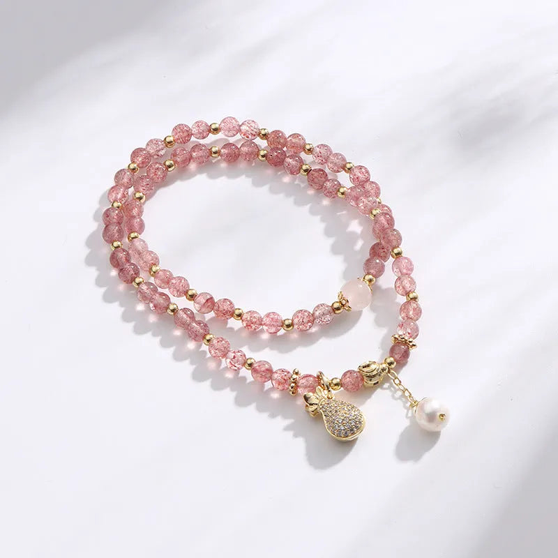 Women's geometric strawberry quartz crystal bracelet for money drawing and luck.