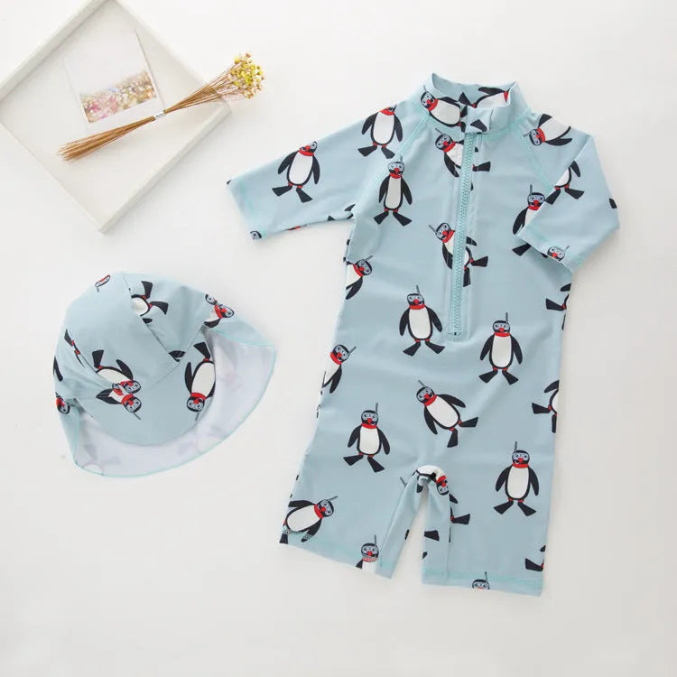 Boys' penguin print long sleeve swim shirt and matching swim cap set.
