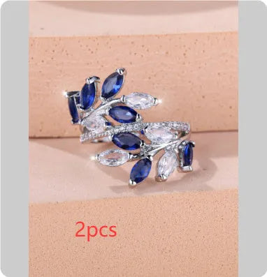 Adjustable copper leaf ring with zircon detailing in multiple colour options on display