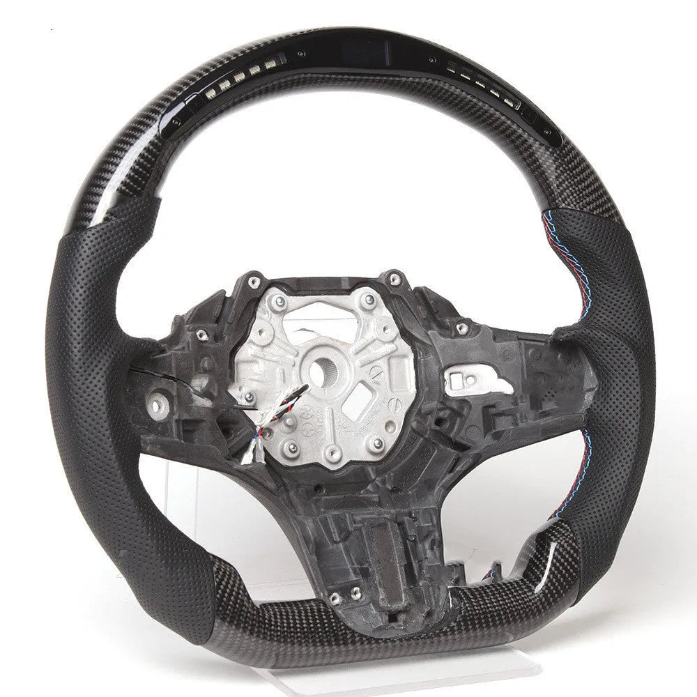 Black carbon fibre steering wheel for BMW with integrated LED display and heating function.