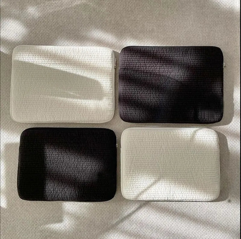 Black and white anti-seismic cotton laptop bag shown in three sizes for tablet protection