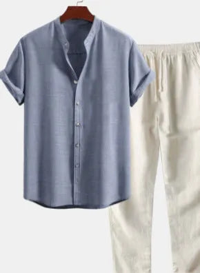 Man wearing a loose-fit short-sleeve shirt and trousers from a casual linen-blend suit set.