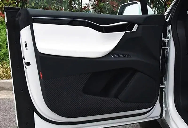 Four-piece carbon fibre pattern protective film kit for Tesla Model S car door interior panels.
