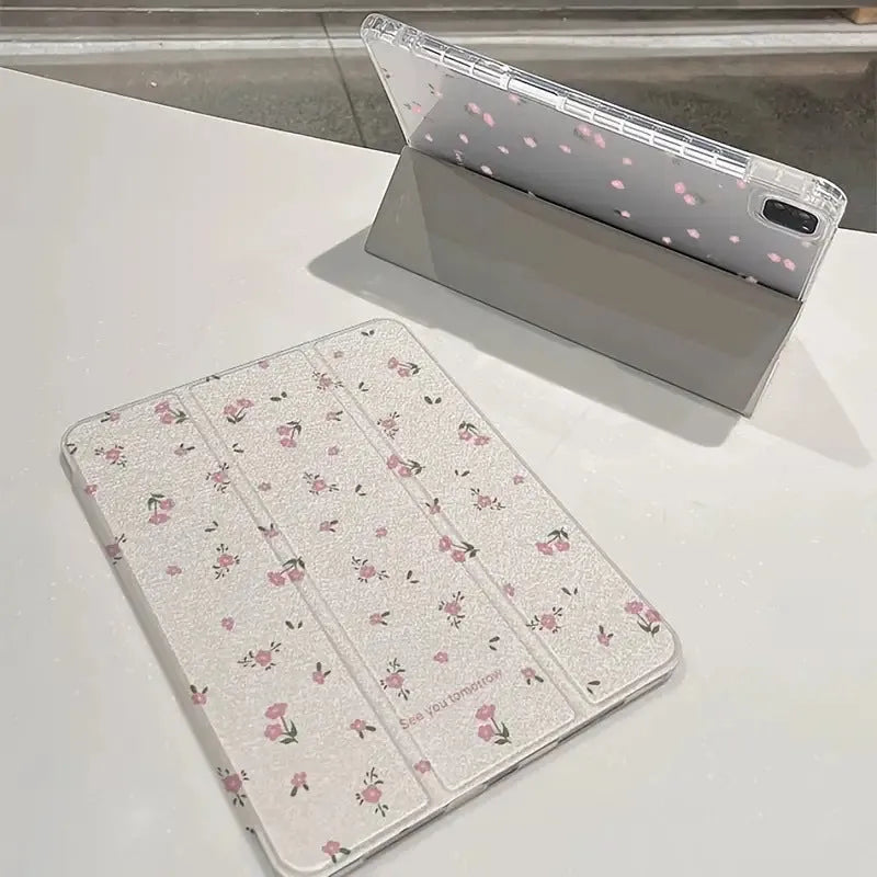 Transparent floral tri-fold iPad protective case with built-in stand, shown closed with magnetic clasp.