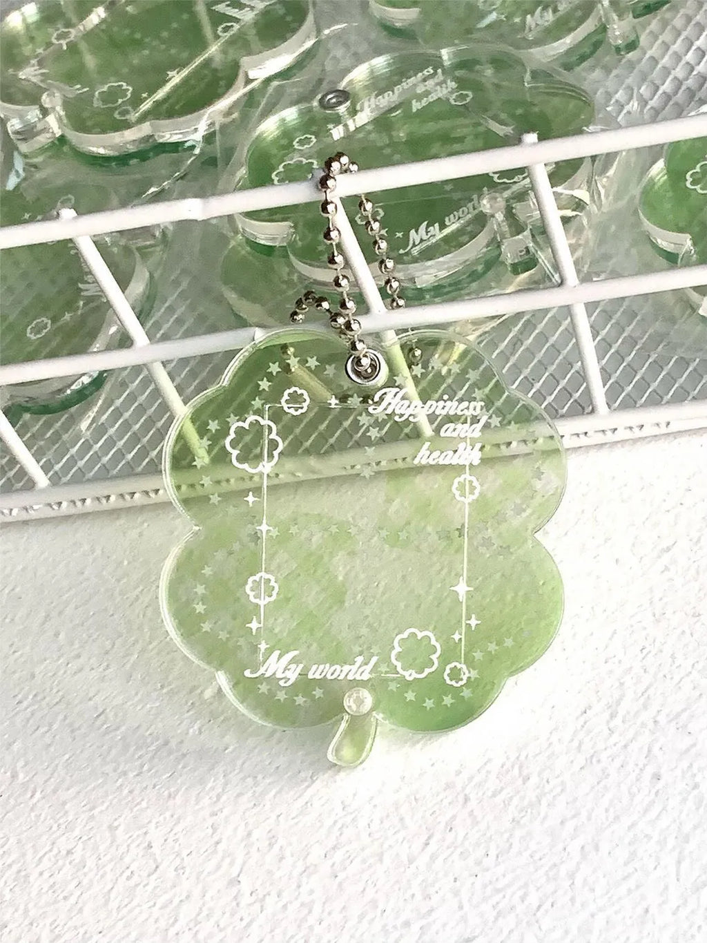 Acrylic four-leaf clover shape mobile phone pendant keychain in blue or green.