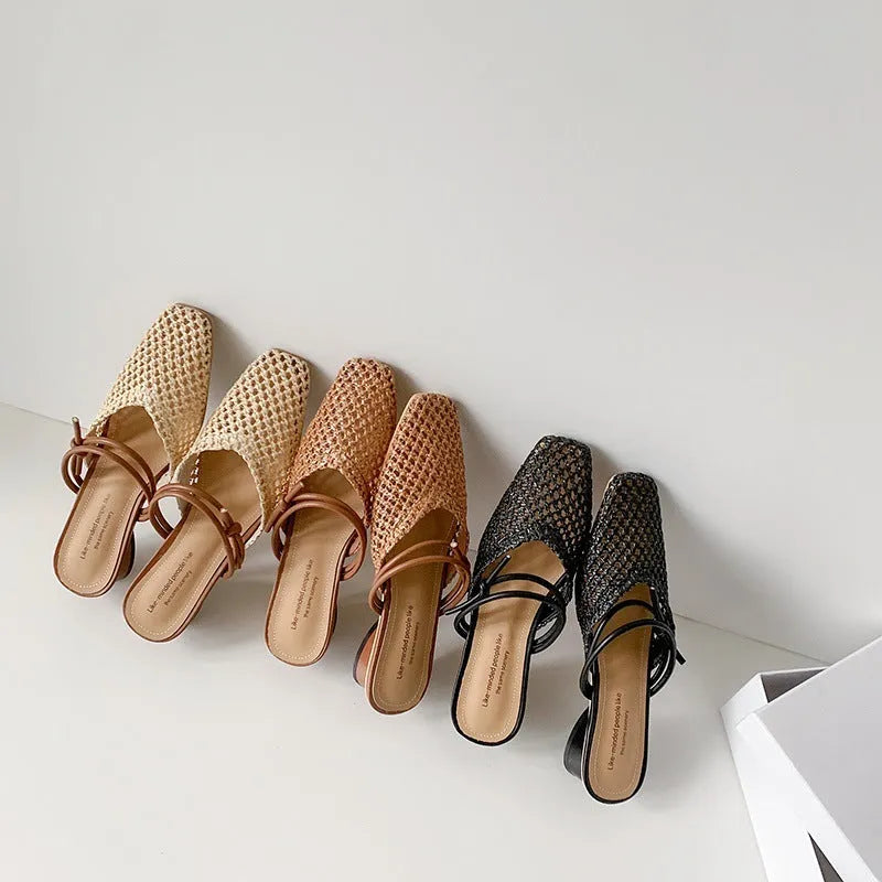 Women's black French-style square toe slippers with hollow-out design and a chunky mid-heel on a rubber sole.