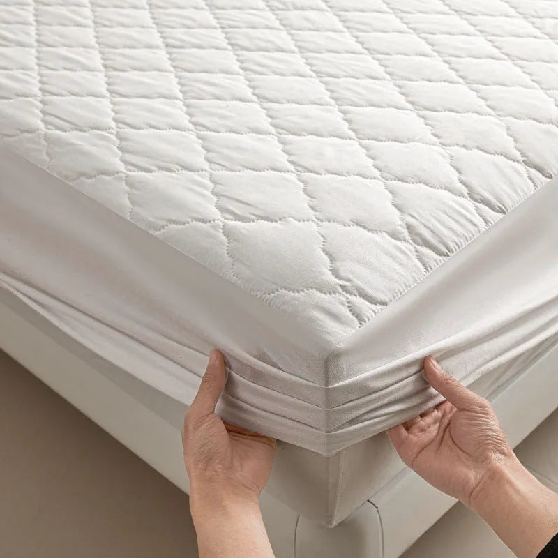 Diamond lattice quilted waterproof mattress protector set with fitted sheet and pillowcases in solid colour.