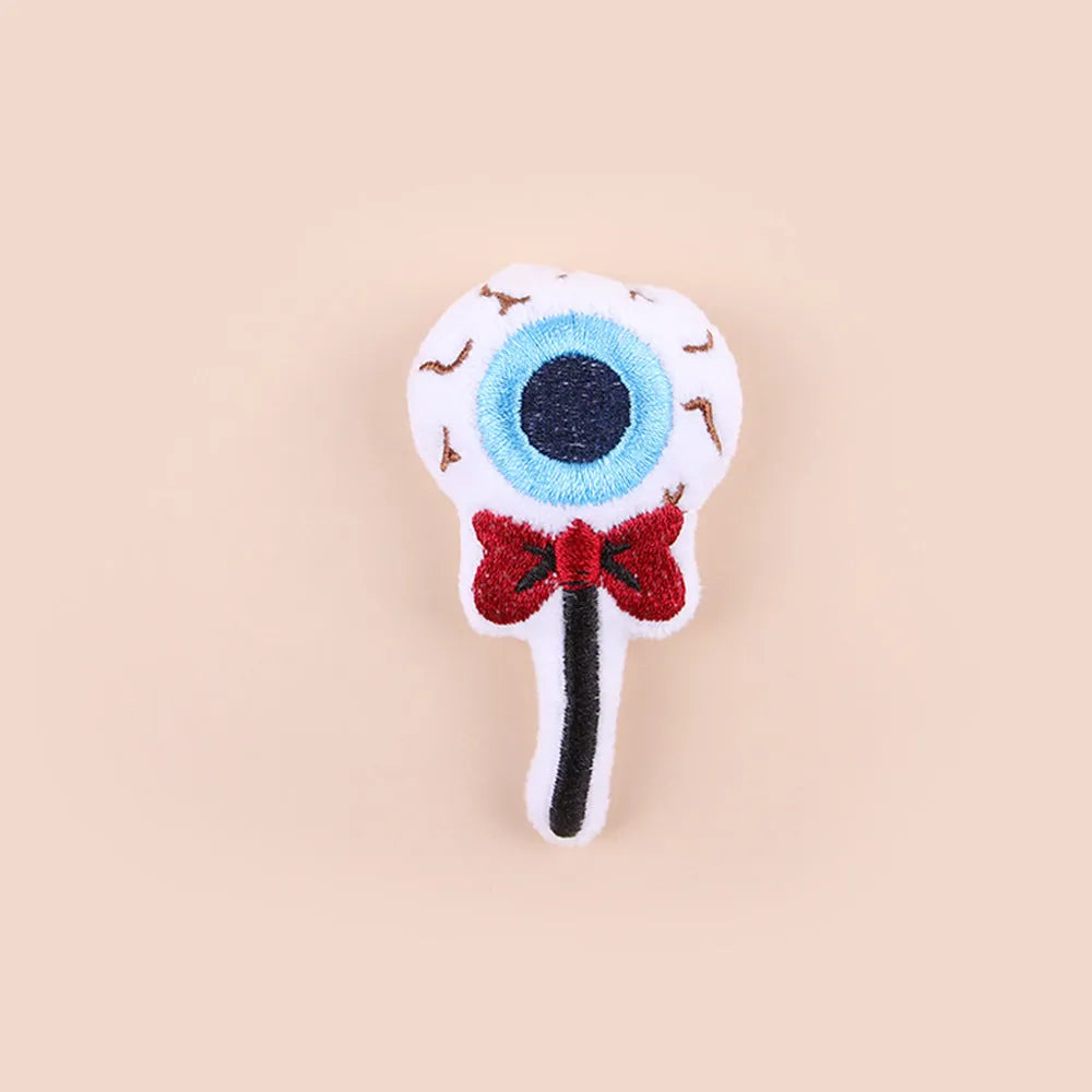 Small cat teaser wand with candy, eyes and skull plush attachments