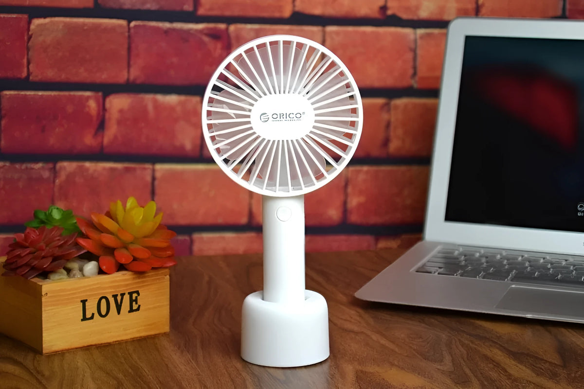 ORICO FH1 white portable USB rechargeable fan with three-speed settings on a desk.
