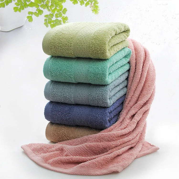 Thickened cotton blend bath and beach towel shown in multiple colour options including green, blue, and pink variations.