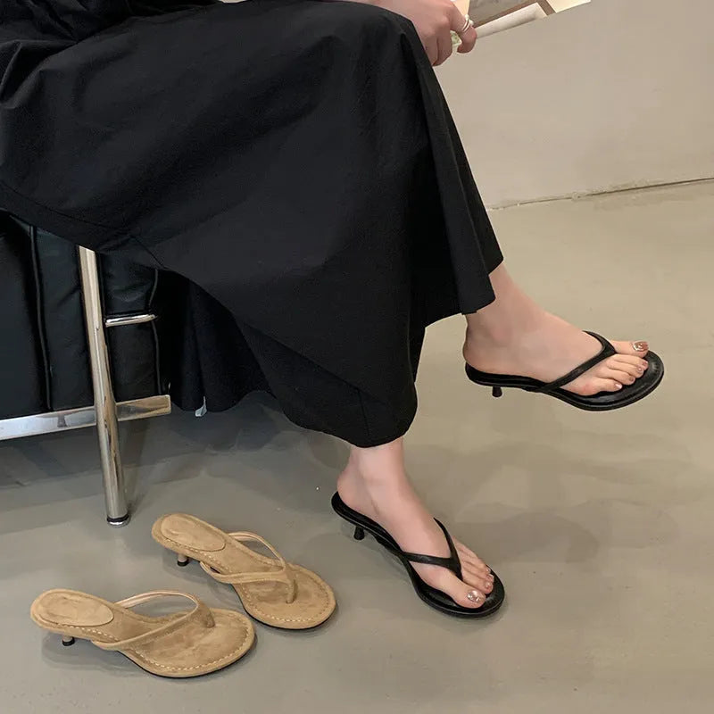 Women's round toe stiletto flip-flop sandals in black and camel colours on a rubber sole.