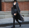 Long grey knitted hooded cardigan coat with trench coat styling on a model.