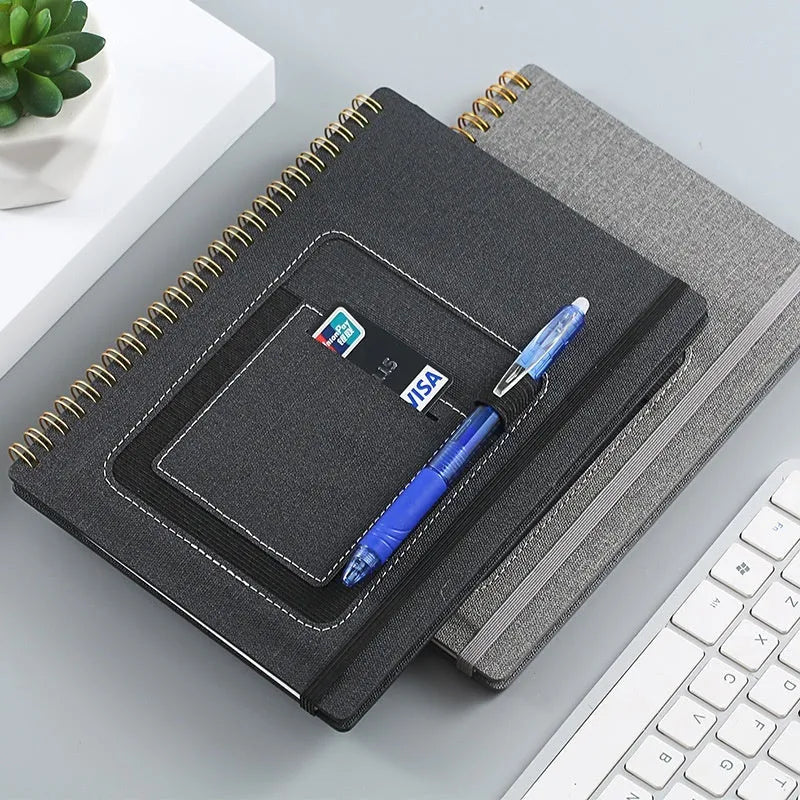 Erasable rock paper coil notebook with custom cover options, shown with a pen.
