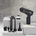 Black wireless handheld car vacuum cleaner with multiple nozzles on a black background