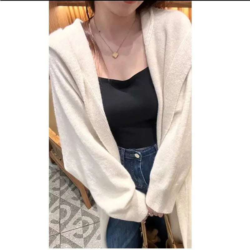 Women's long brown knitted hooded cardigan with a loose fit and below-the-knee length.