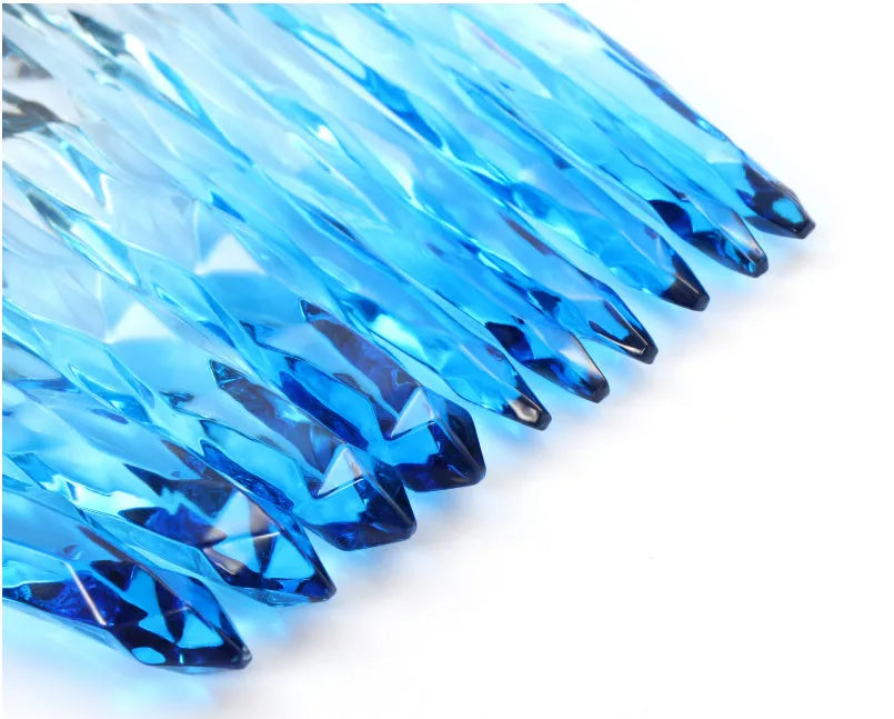 Ten clear crystal-handled foundation brushes with artificial fibre bristles, laid out in a set.