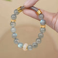 Light green Tian Shan Cui jade women's half bracelet with floating flower girl design in Chinese folk style.