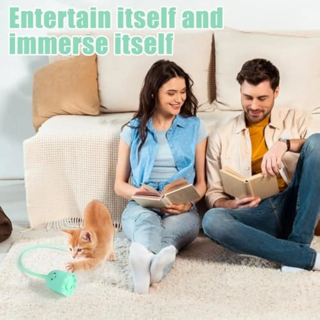 Green automatic cat wand toy with a swinging silicone tail on a white background.