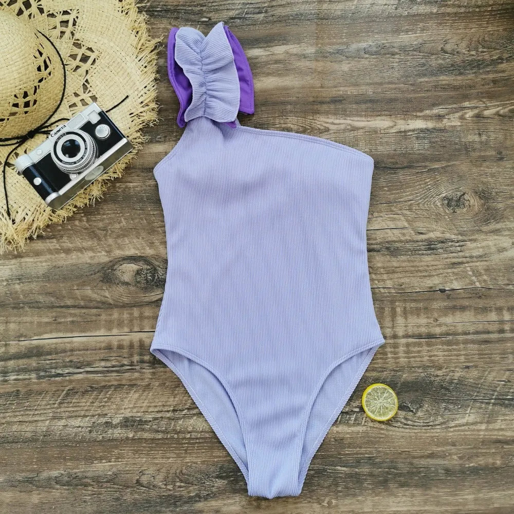 Women's single-shoulder high-waist one-piece swimsuit in a solid colour.