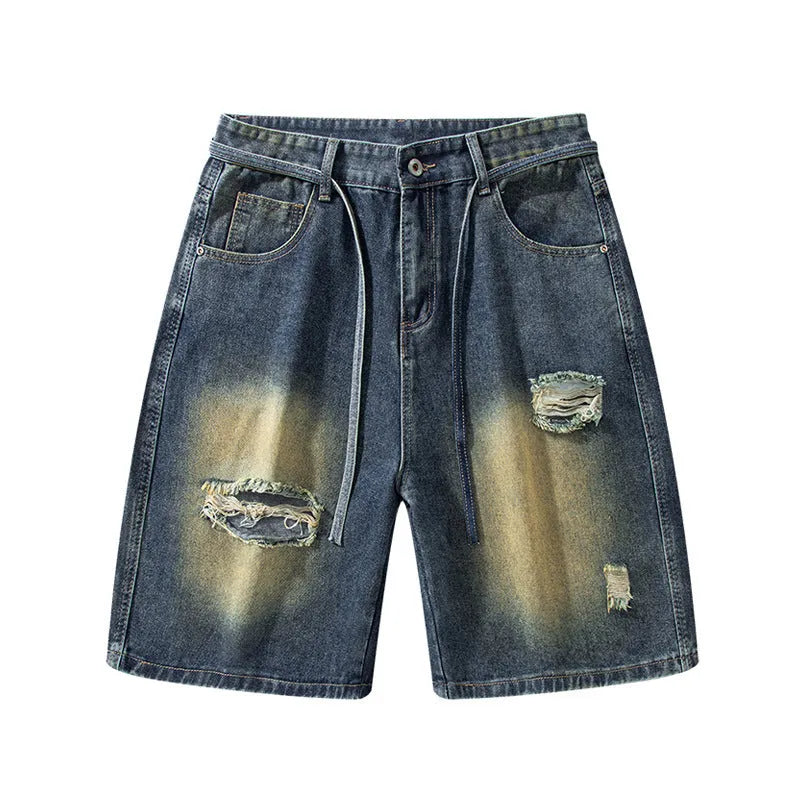 Man's loose-fit ripped jeans in retro blue denim, showing distressed detailing on legs.