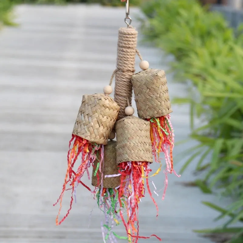 Colourful shredded paper parrot toy with wood and sisal construction measuring 15cm by 35cm