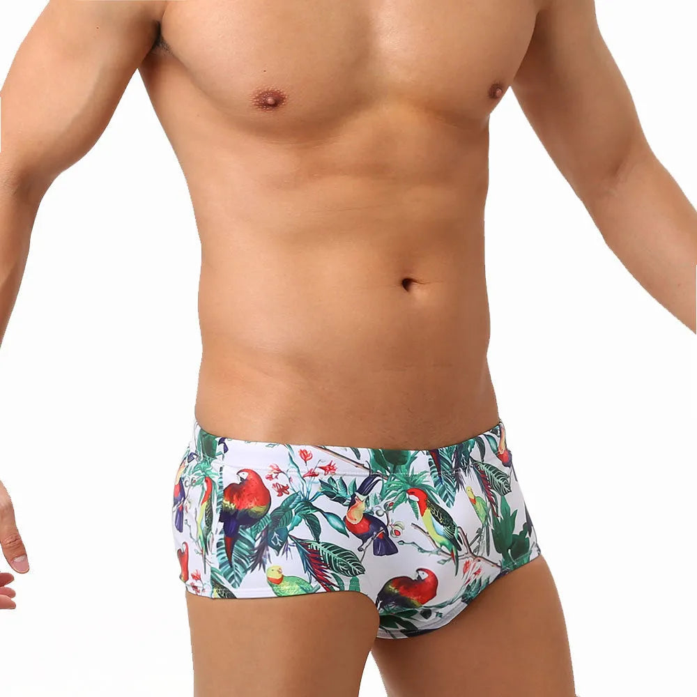 Men's floral bird print nylon swim trunks in boxer style on white background