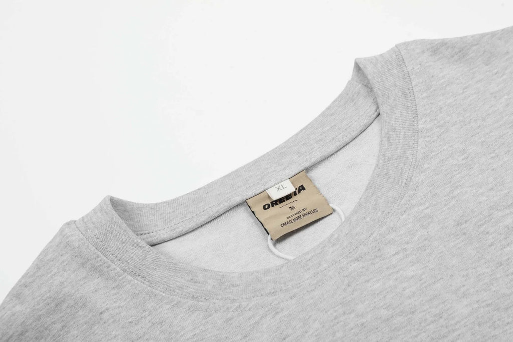 Men's loose fit cotton pullover top in black and floral grey colours on a hanger