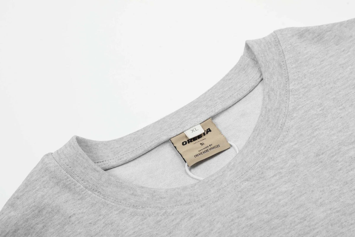 Men's loose fit cotton pullover top in black and floral grey colours on a hanger