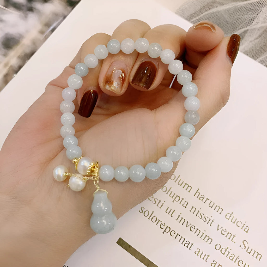 Women's jade bracelet with natural emerald jade insets and gourd design in Chinese style