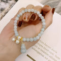 Women's jade bracelet with natural emerald jade insets and gourd design in Chinese style