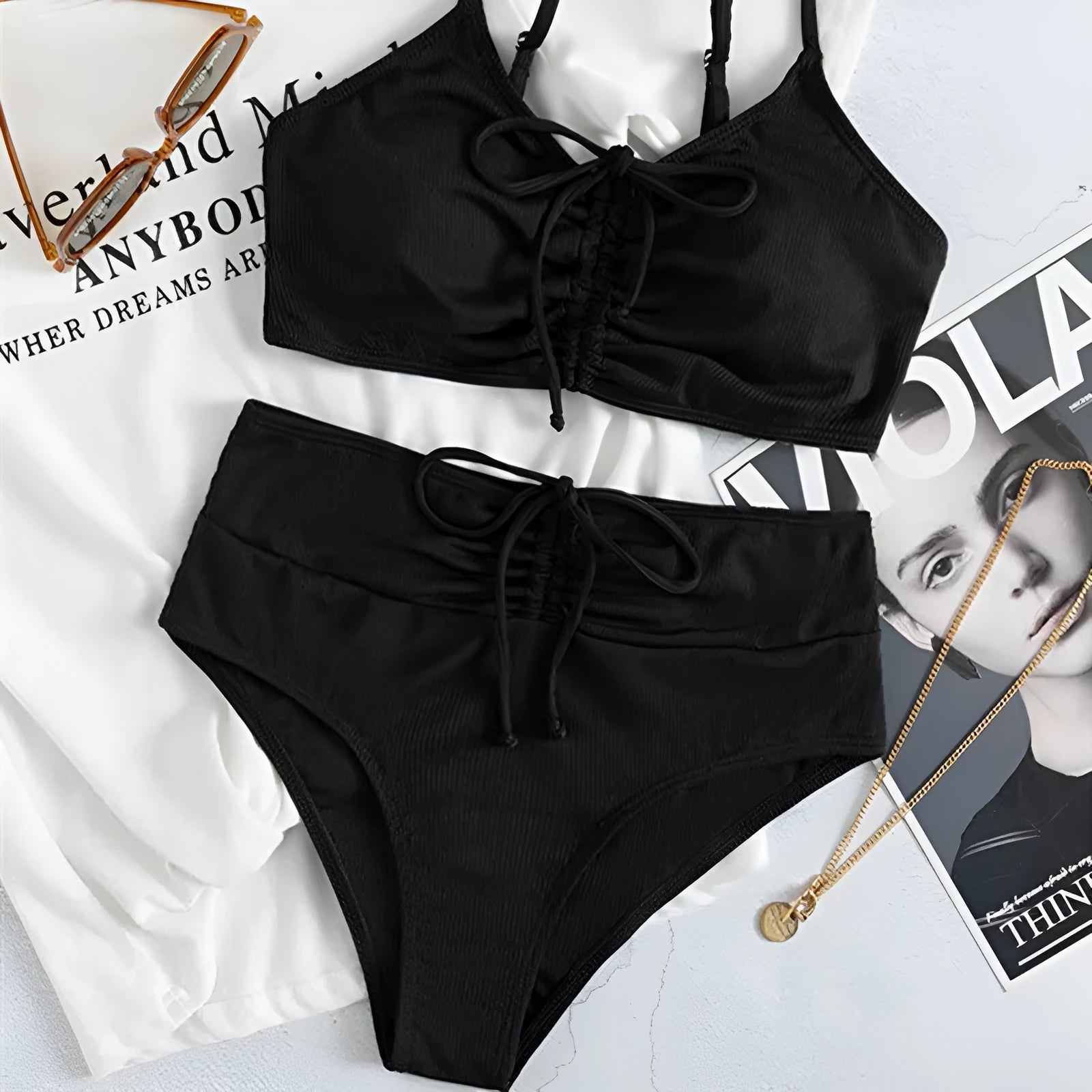 Black women's bikini swimsuit with high-waist shorts and sling split design.