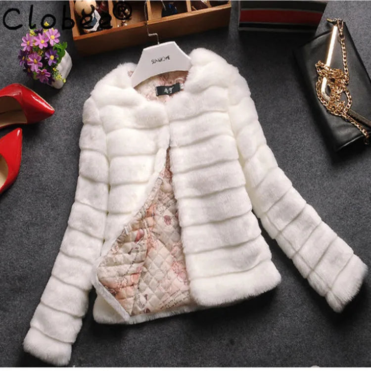 A woman's short faux fur top in beige, shown on a hanger.