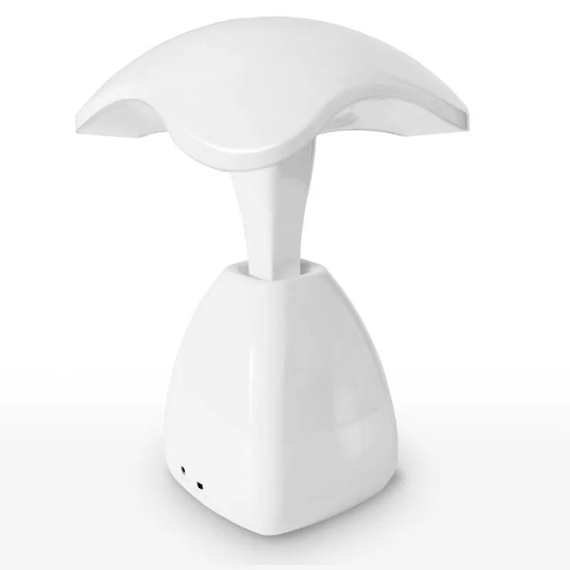 White modern LED desk lamp with a plastic shade and touch switch on a table.