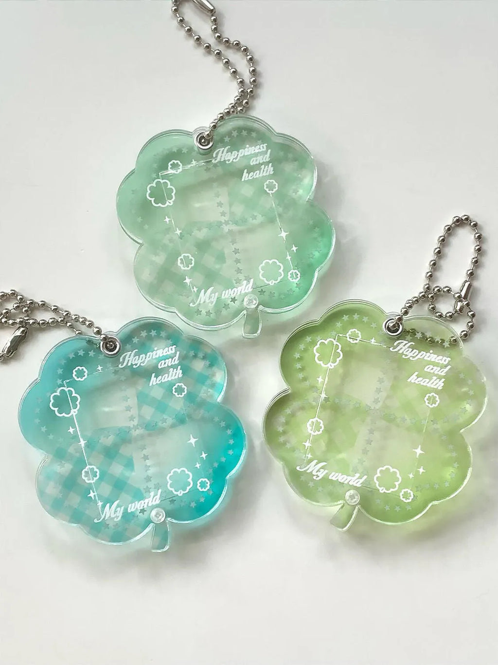 Acrylic four-leaf clover shape mobile phone pendant keychain in blue or green.