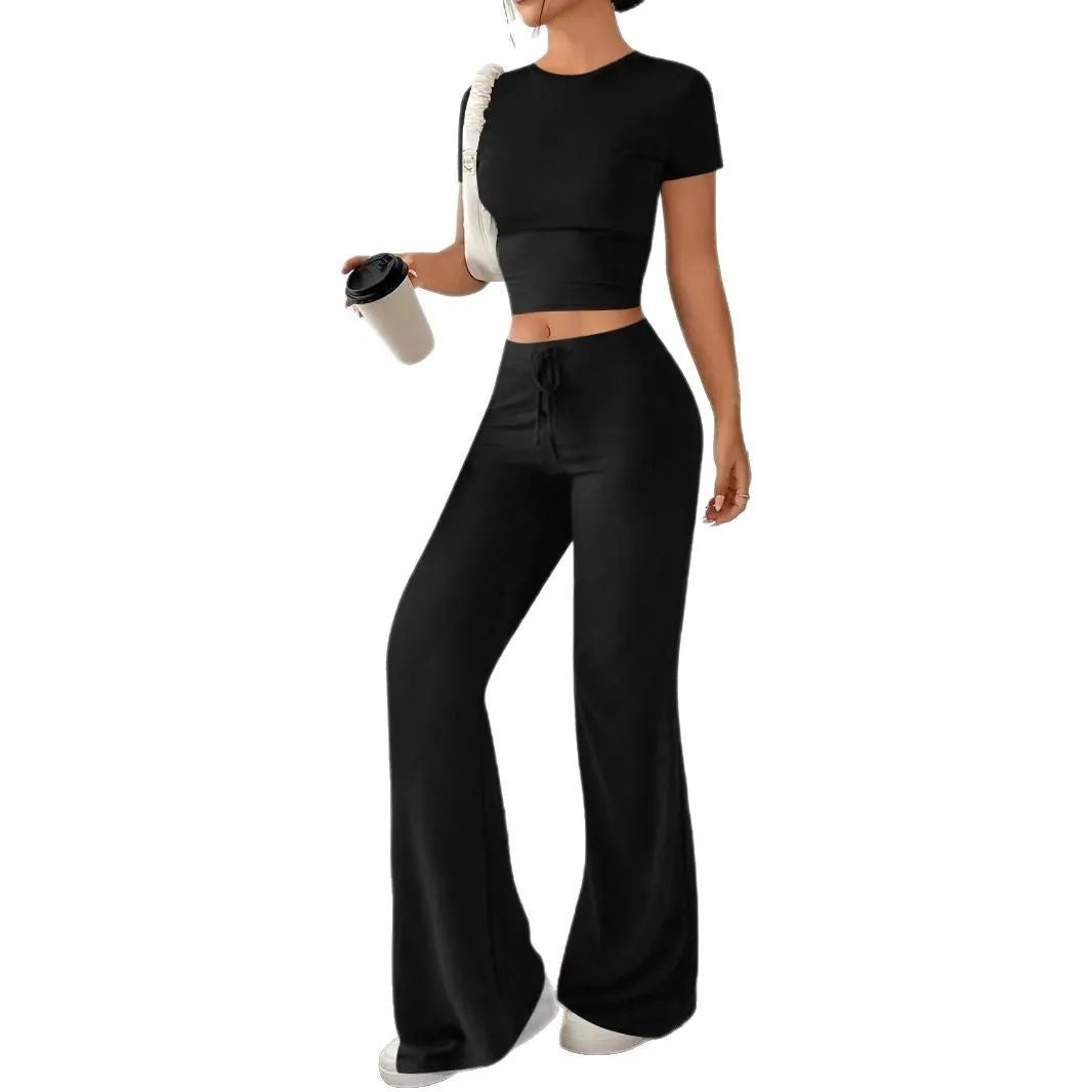 Black women's high waist trousers and short sleeve top coordinated suit set on a hanger.