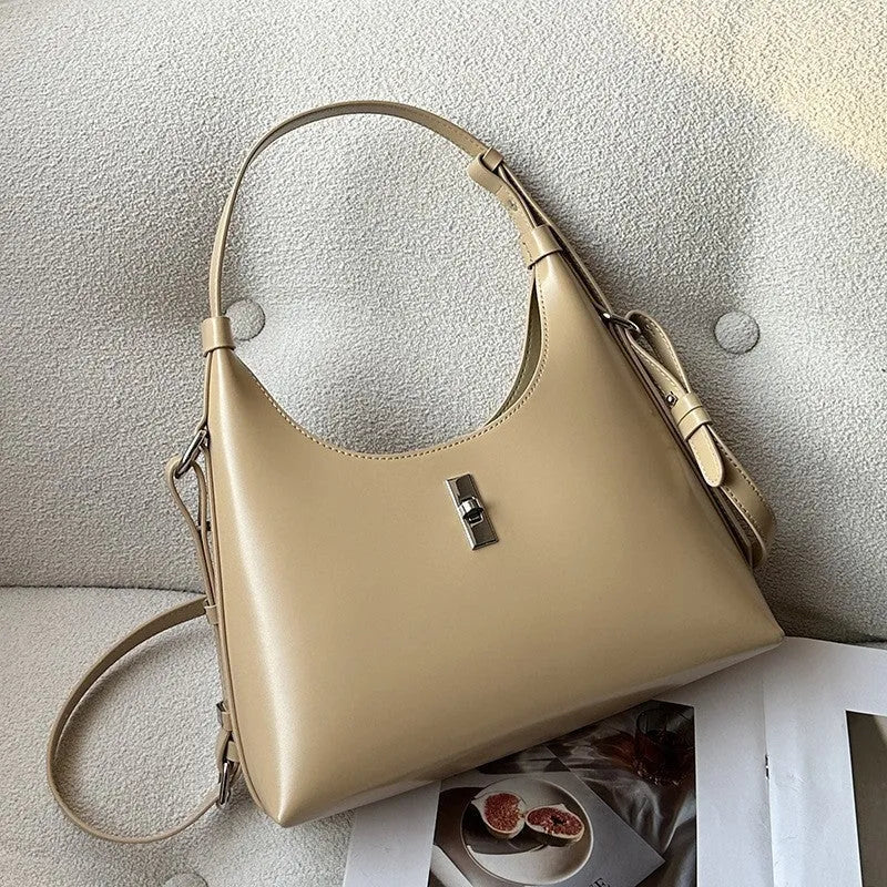 Soft genuine leather dumpling-shaped crossbody bag in apricot with sewing thread detail.