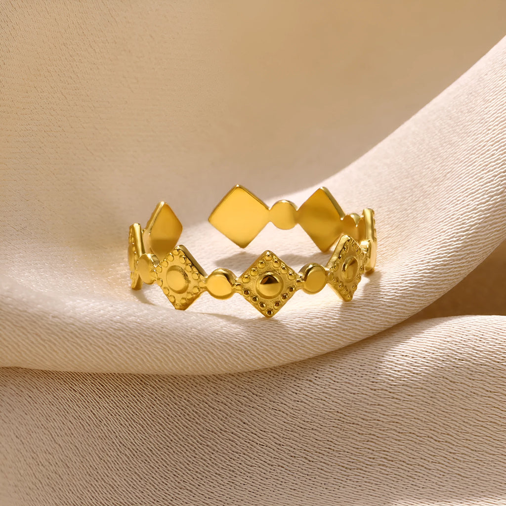 Geometric titanium steel women's ring with gold diamond finish shown on hand