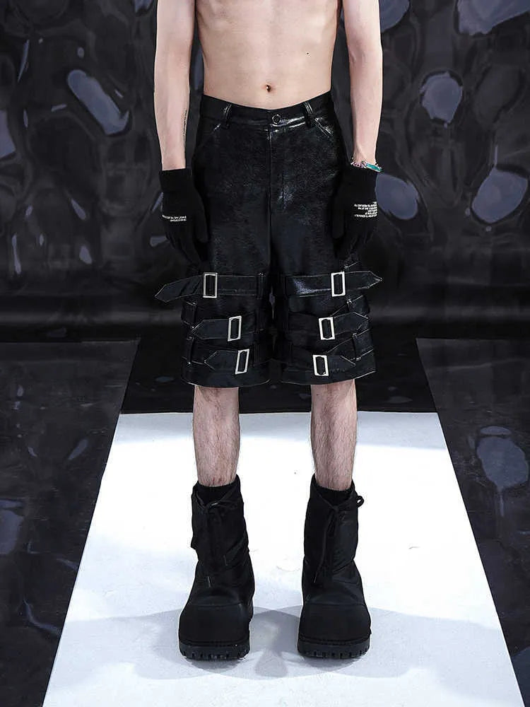 Men's black PU leather casual shorts with cropped length and a leather ring detail on the front.