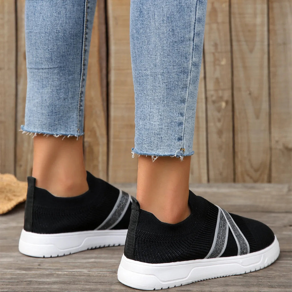 Black women's flyknit mesh casual shoes with flat rubber sole and round toe.