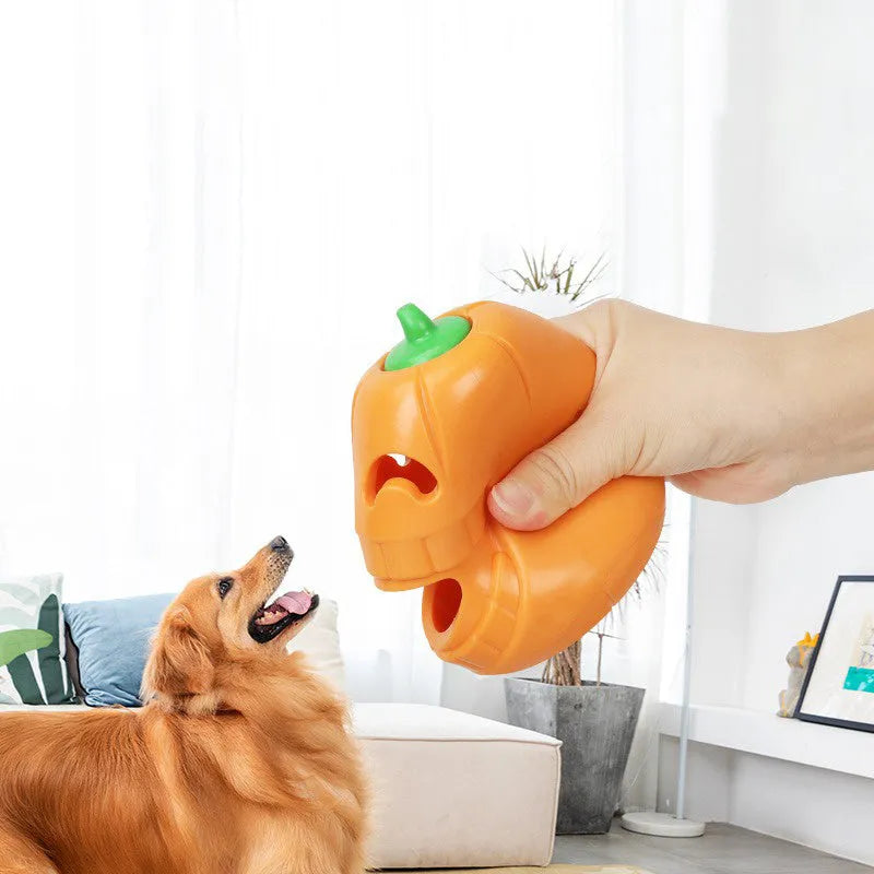Orange Halloween pumpkin shaped dog chew toy with a treat-dispensing funnel opening.