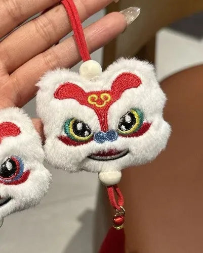 Blue and yellow handmade plush cartoon lion keychain with long tassel and star stone decoration.