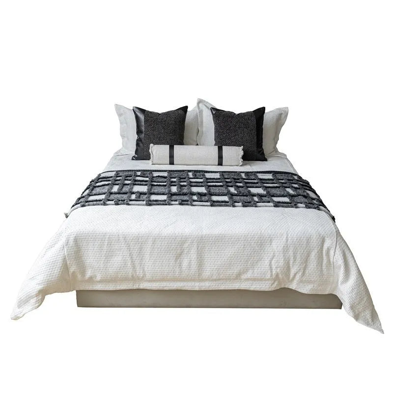 Modern minimalist polyester bed runner blanket set with round pillow and pillowcase on a bed.