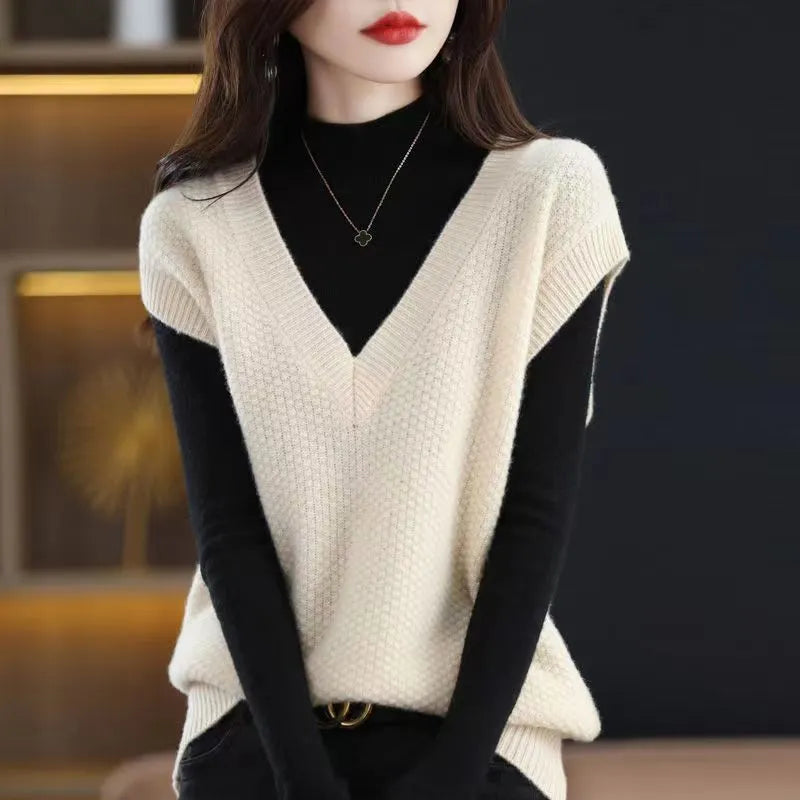 Women's cream V-neck sleeveless knit vest with a raised 3D pattern, laid flat.