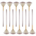 Ten champagne-coloured facial fan brushes with soft bristles and protective covers laid out.